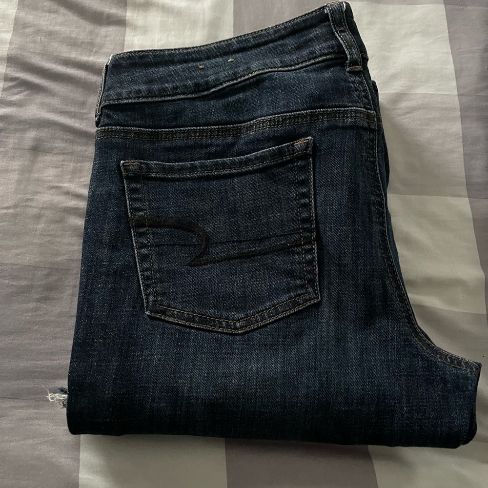 American Eagle Women’s Artist stretch jeans.  Dark blue. Frayed hem. Size 10